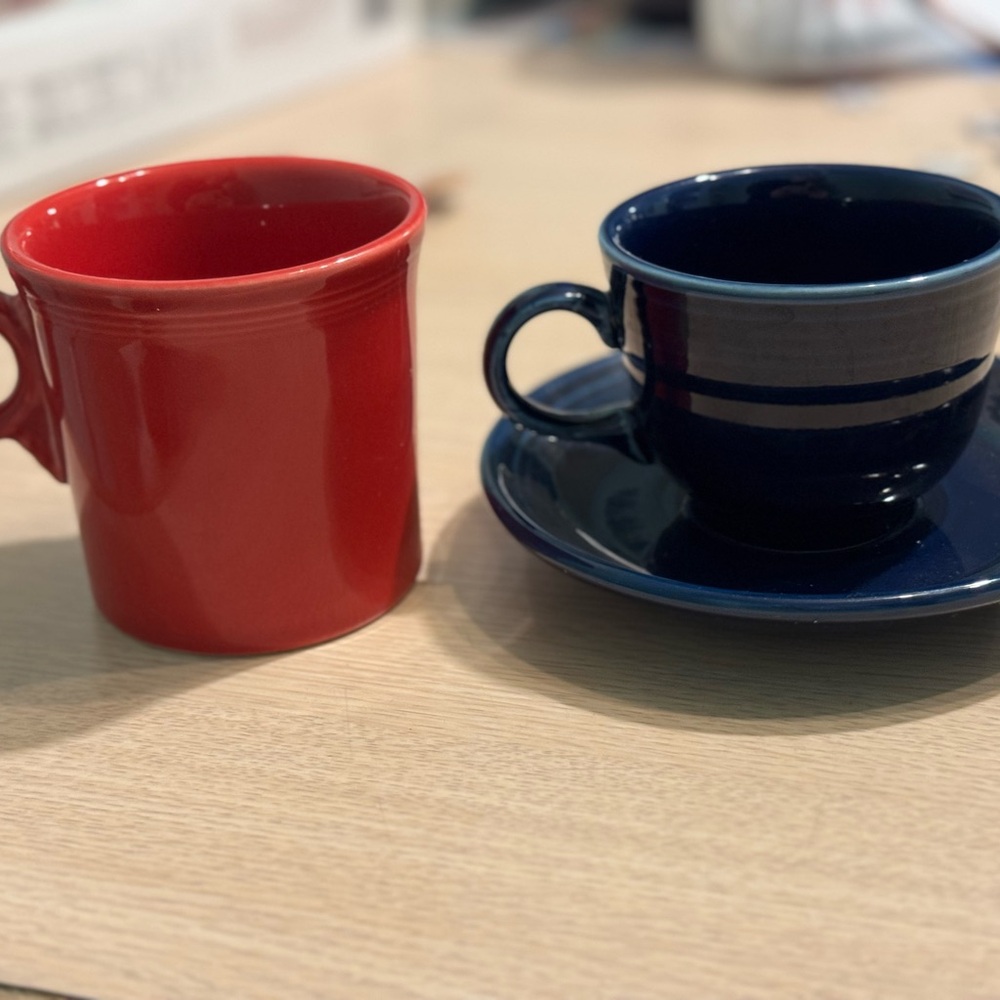 Fiesta coffee mugs and saucers. Five red mugs, four navy blue cups and saucers.